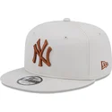 gorra-plana-beige-snapback-con-logo-marron-9fifty-league-essential-de-new-york-yankees-mlb-de-new-era